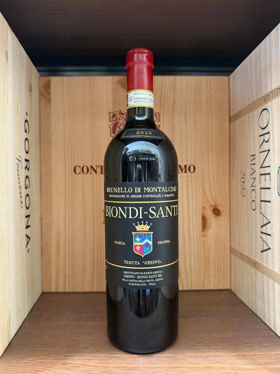 Bottiglia di Brunello di Montalcino 2018 Biondi Santi, vino rosso toscano in una bottiglia elegante, vista frontale su sfondo neutro.