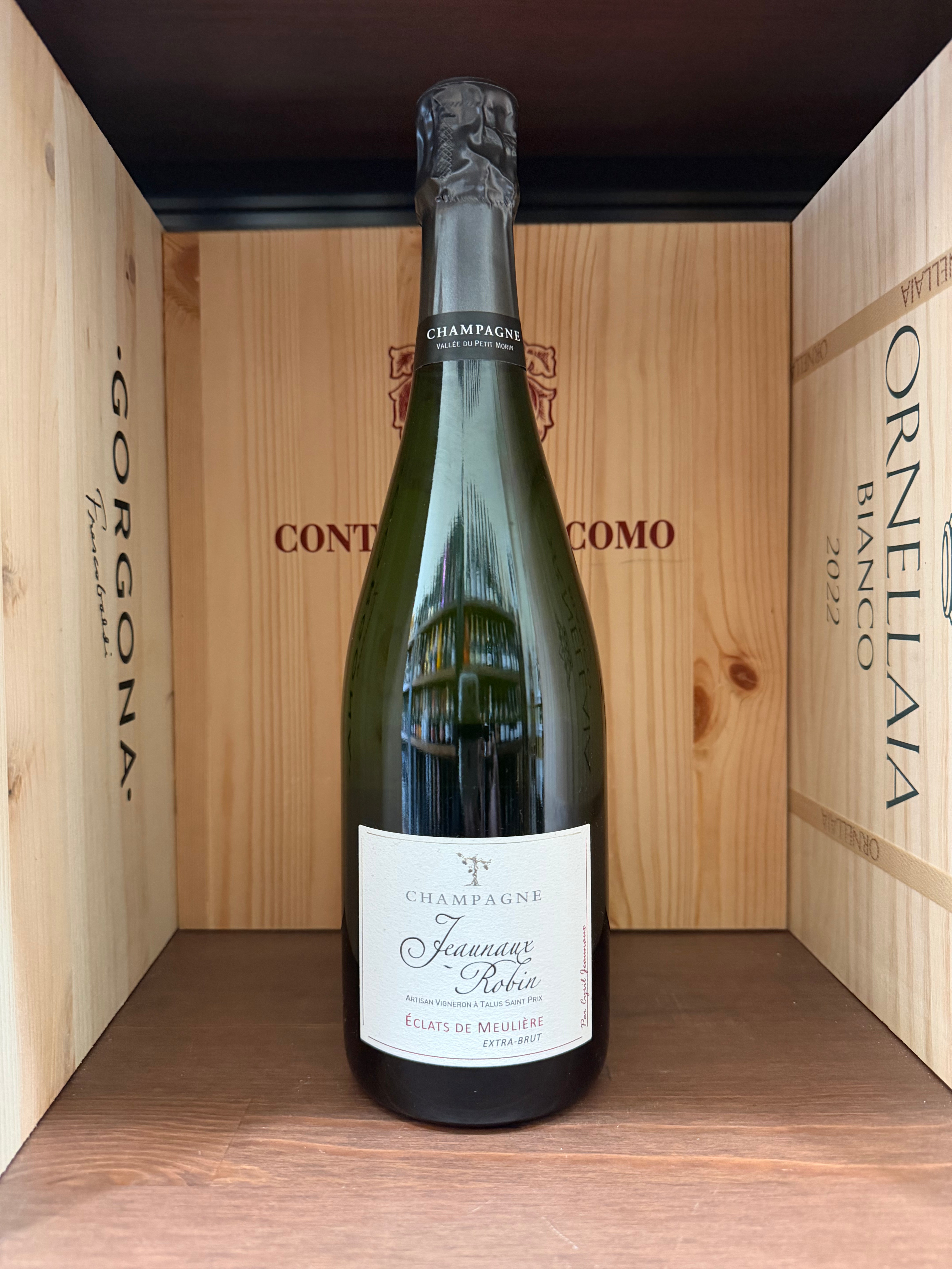Calice di vino spumante Jaunaux Robin Eclats De Meuliére Extra Brut, con bollicine visibili, in un bicchiere elegante.